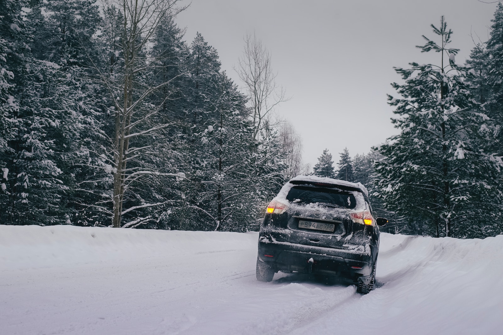 a car driving down a snow covered road